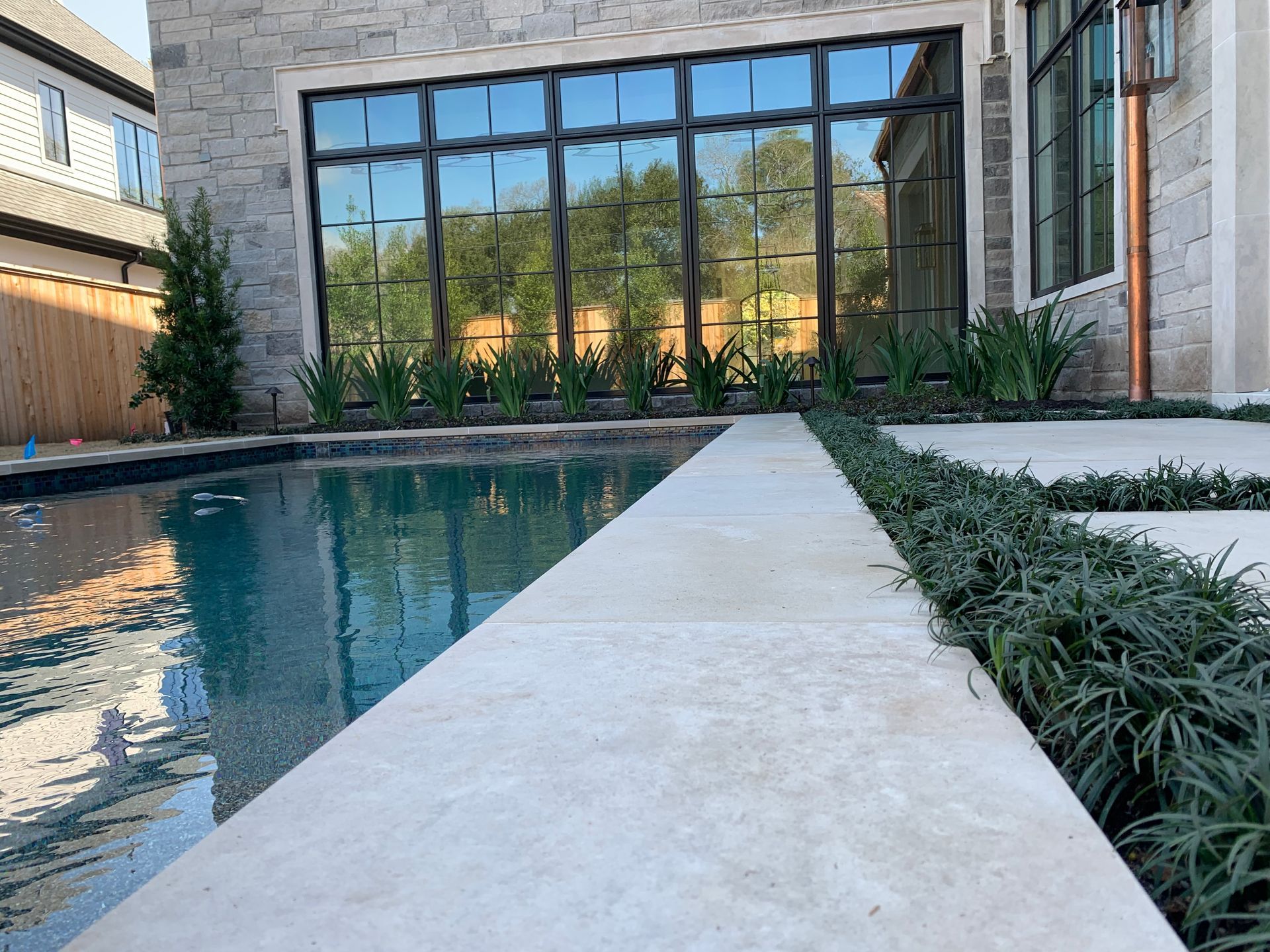 A large house with a swimming pool in front of it.