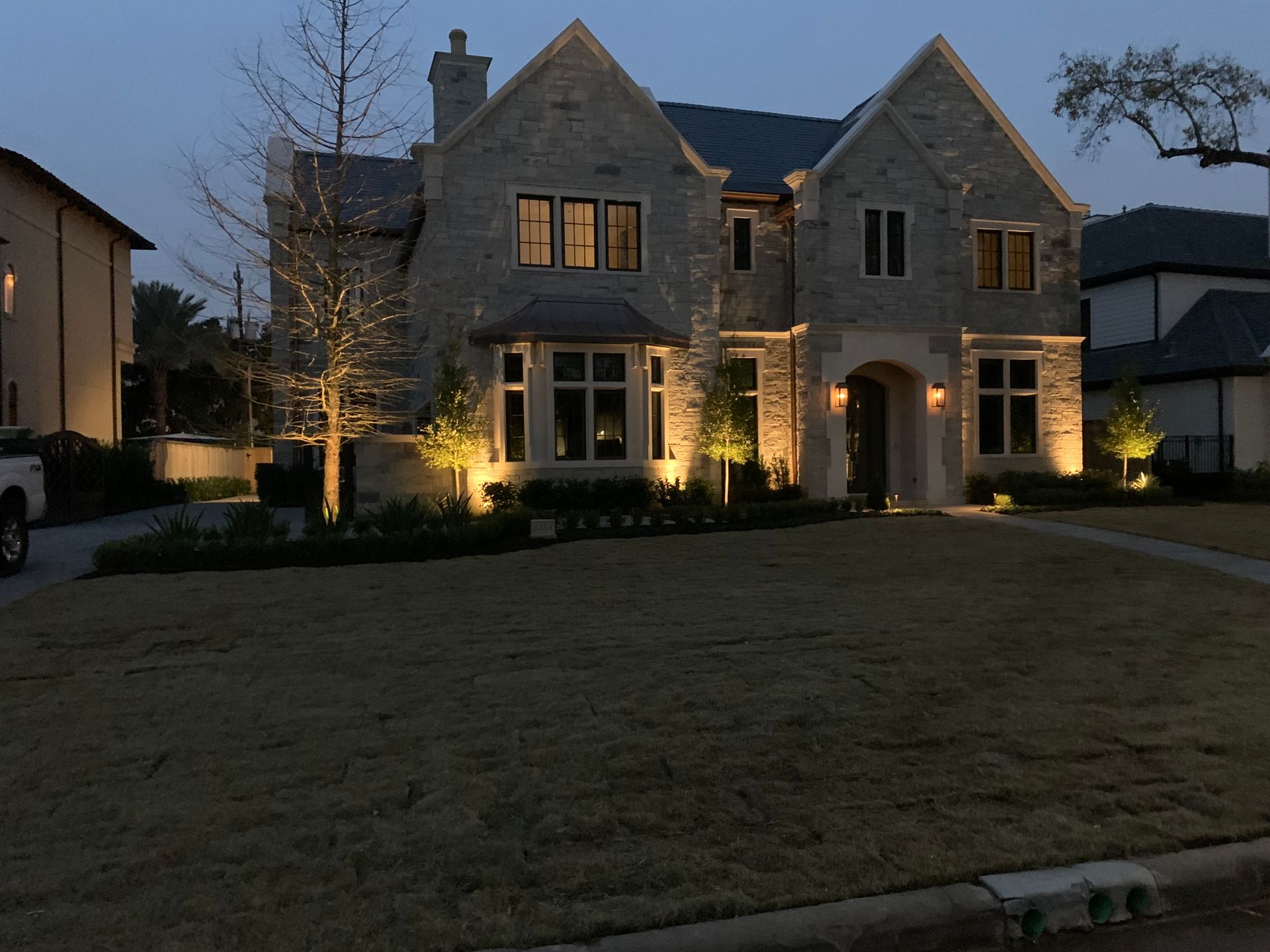 A large brick house is lit up at night