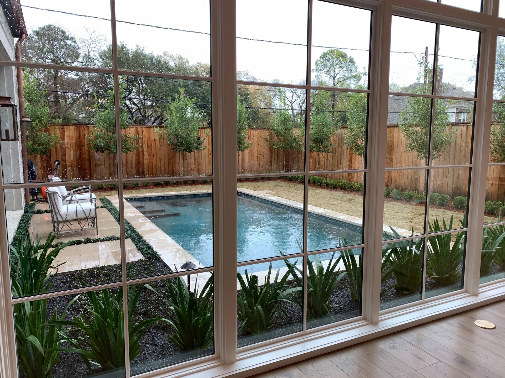 A large window with a view of a swimming pool.