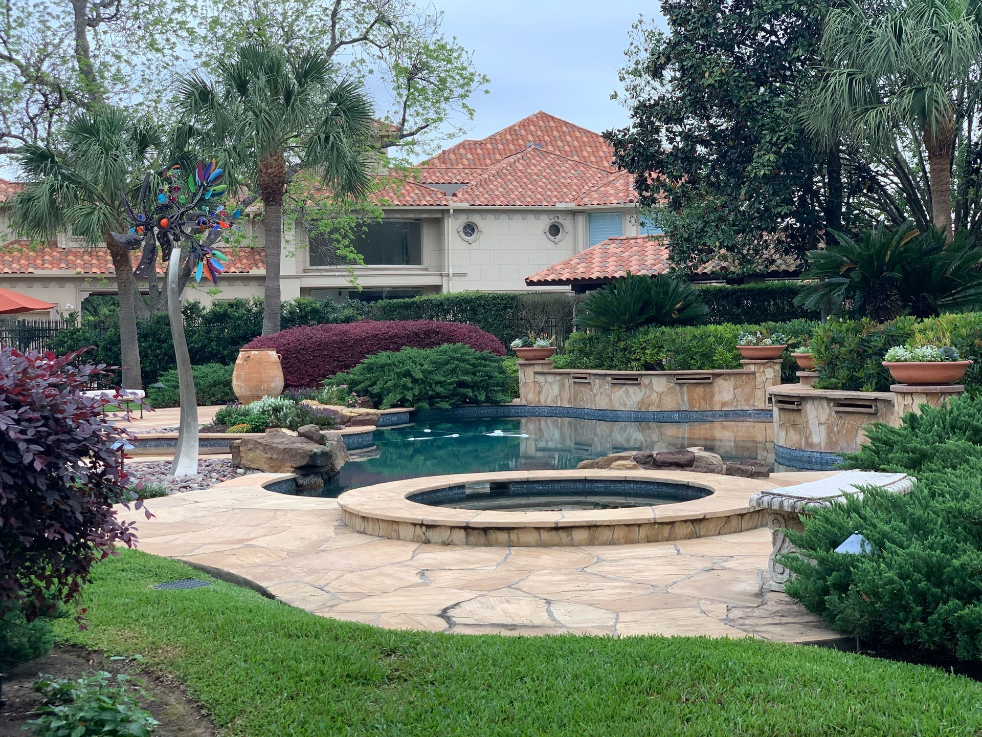 A large house with a swimming pool and a hot tub in the backyard.