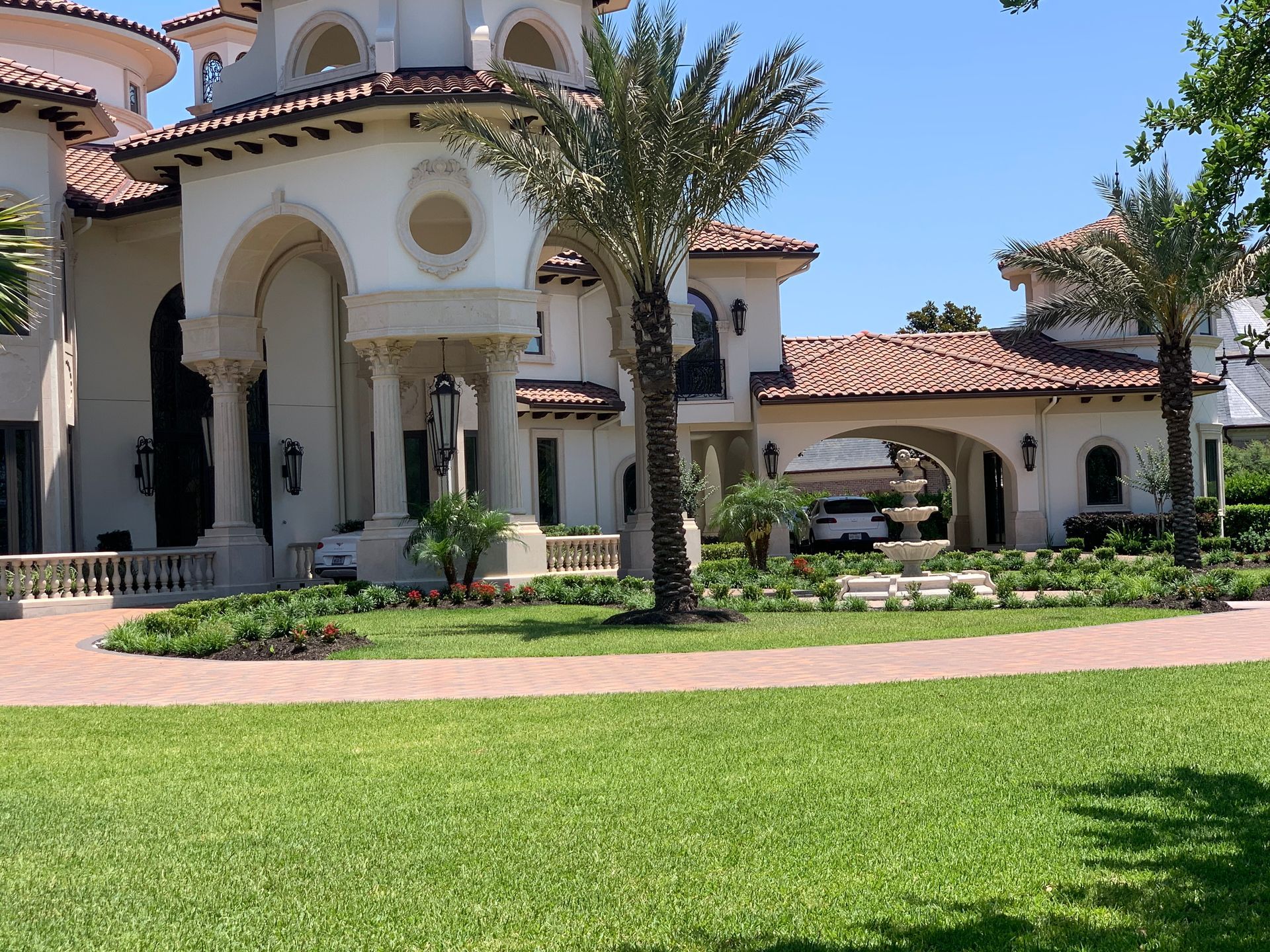 A large white house with a palm tree in front of it
