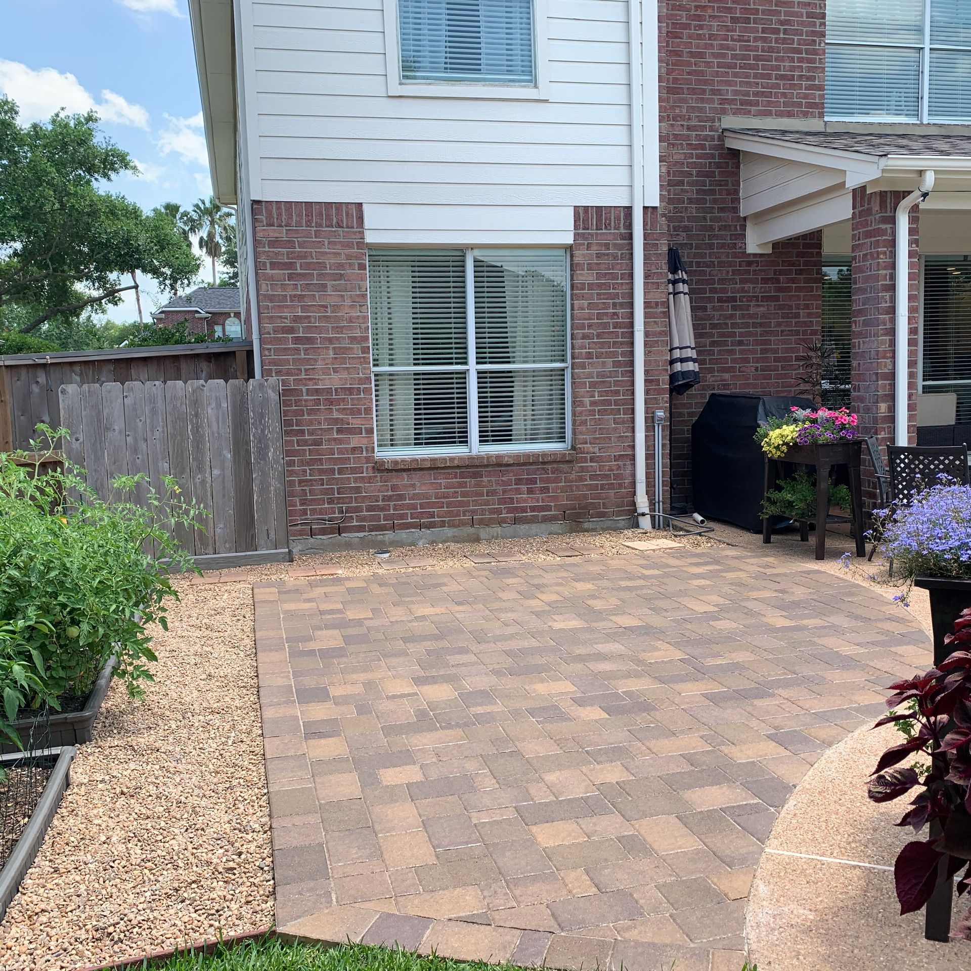 A brick house with a patio in front of it