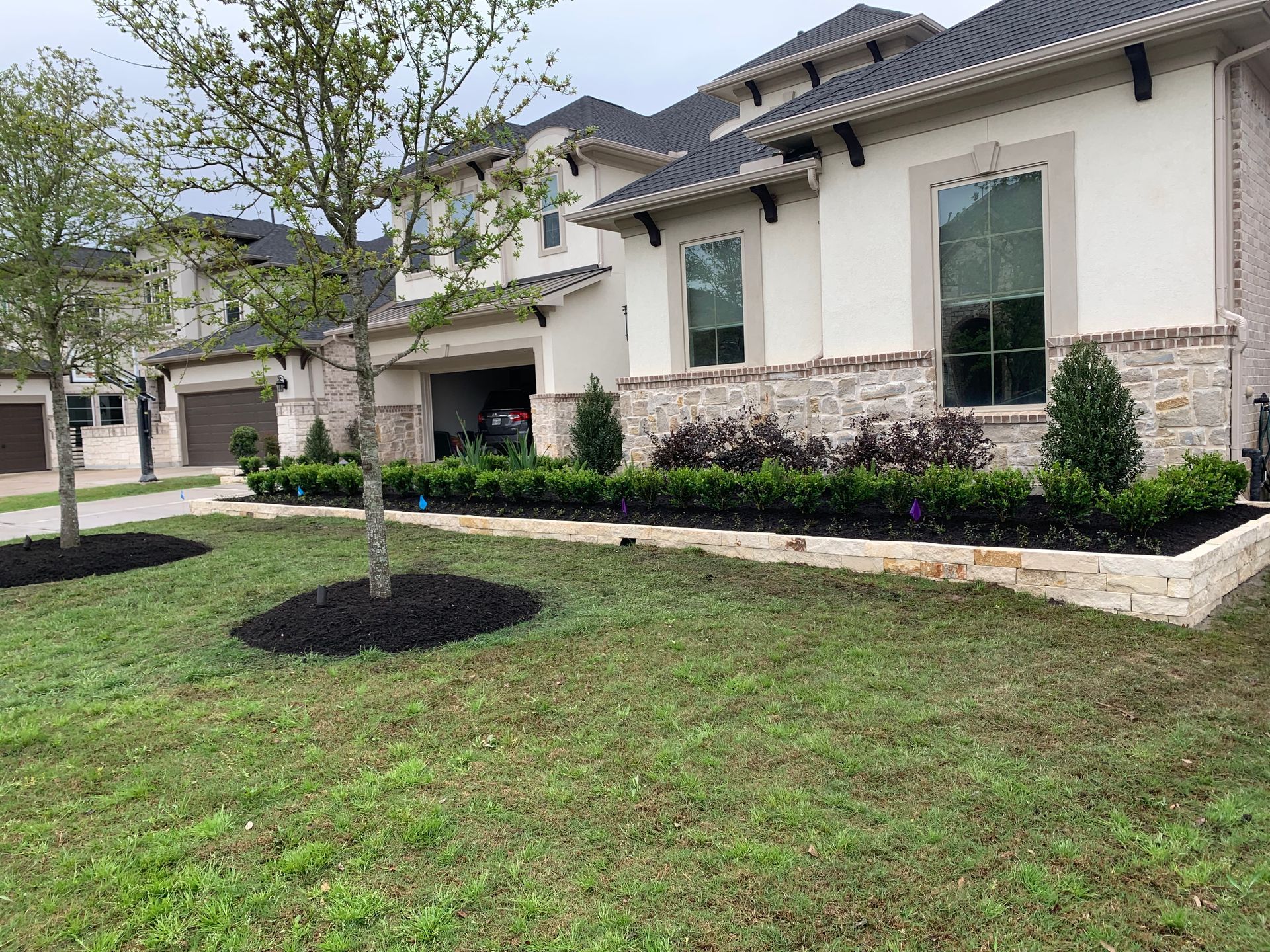 A large white house with a lush green lawn in front of it.