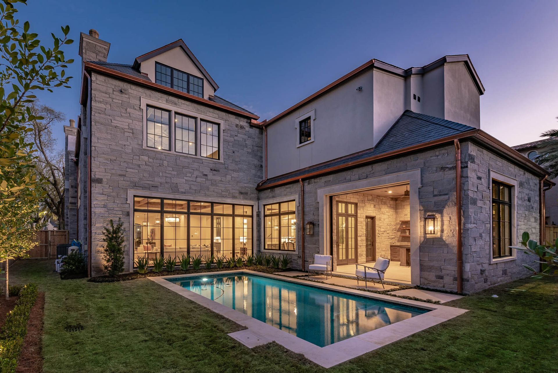 A large house with a large swimming pool in the backyard.