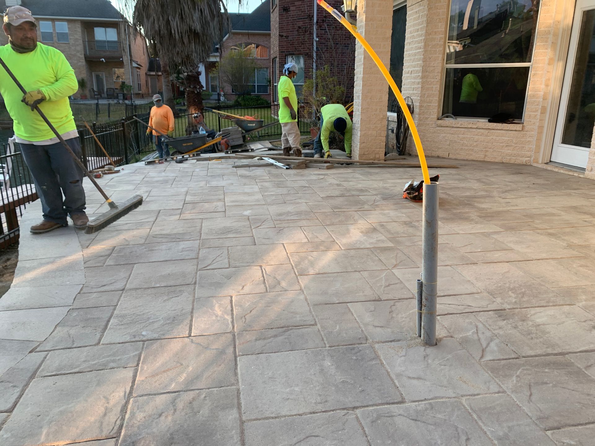 A group of men are working on a patio.
