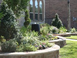 A brick house with a garden in front of it