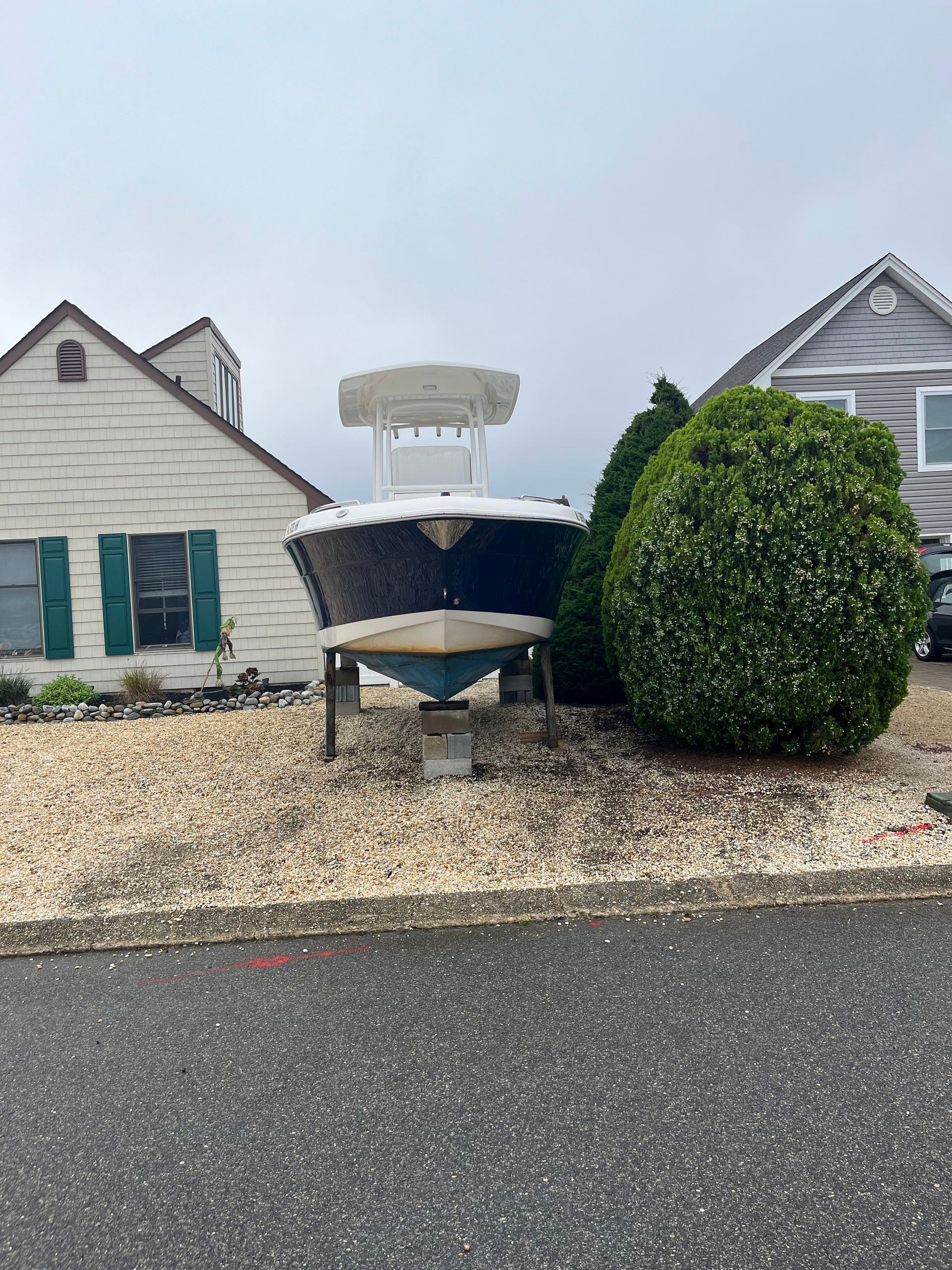 A boat is parked in front of a house.