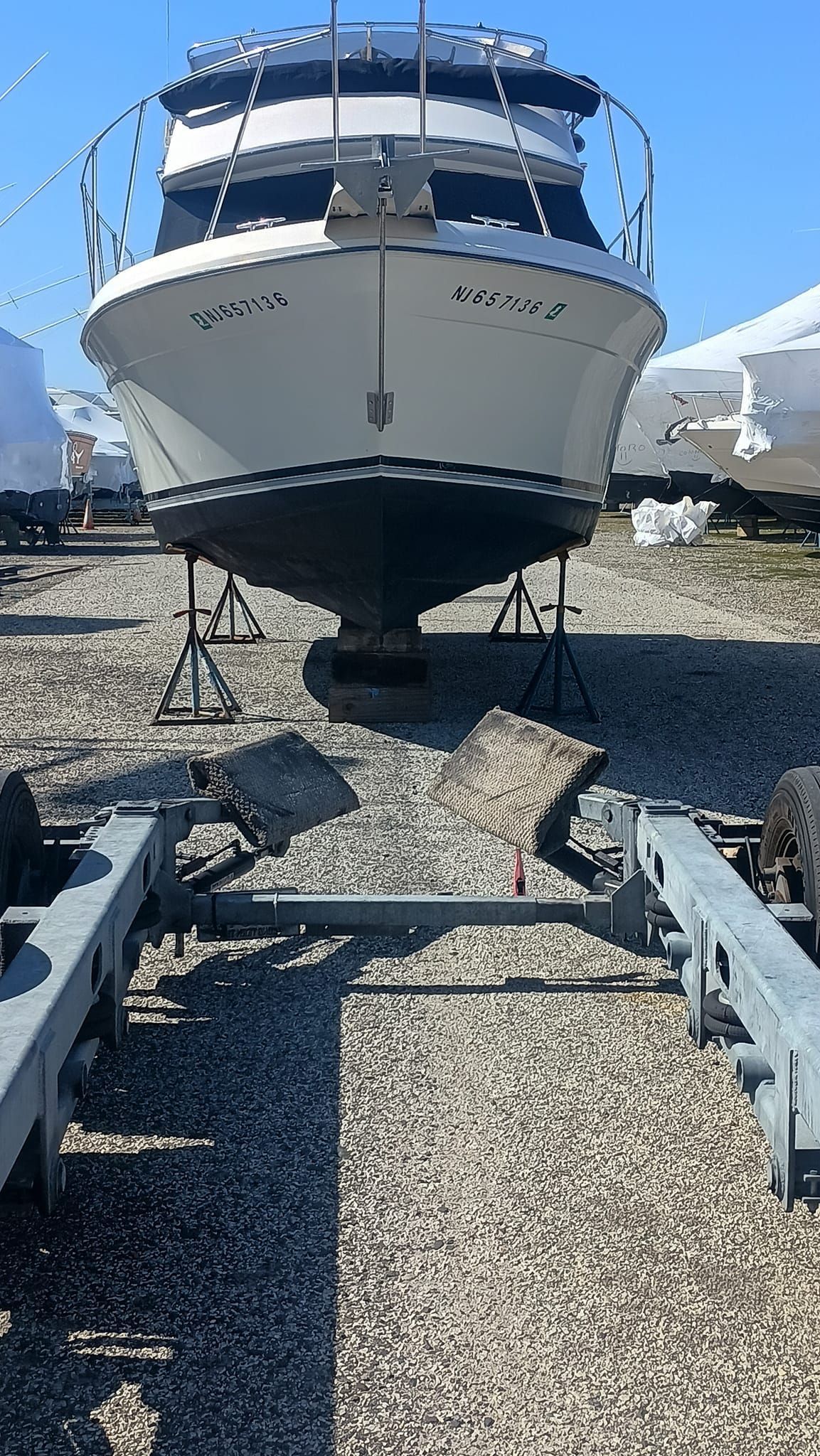 A fenced in area with boats and a sign that says lifeboat marina