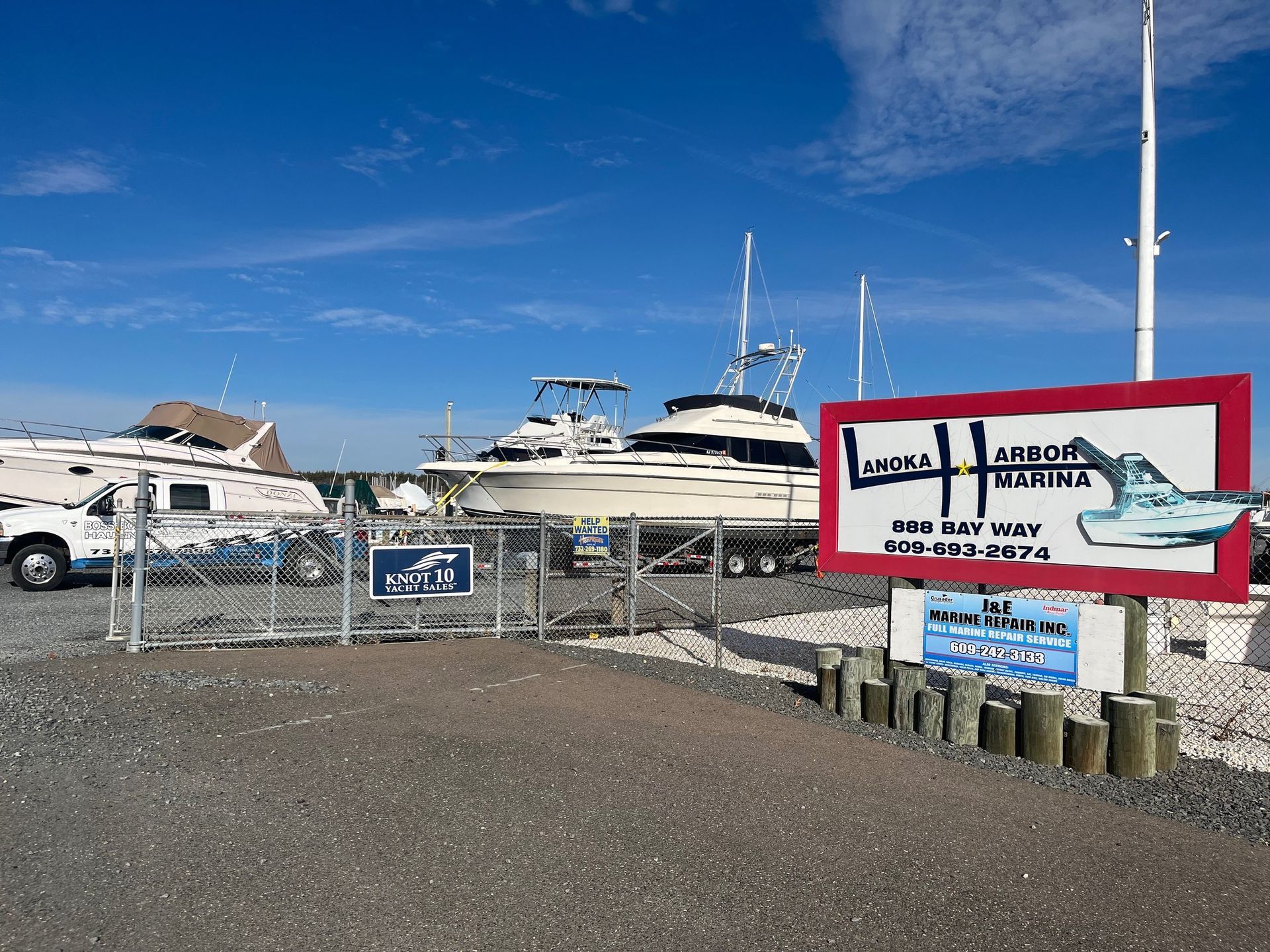 A fenced in area with boats and a sign that says lifeboat marina