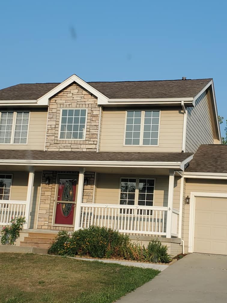 A house with a large porch and a garage