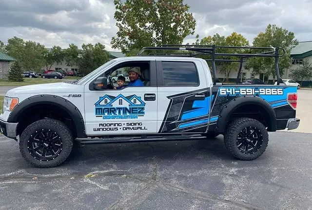 A white pickup truck is parked in a parking lot.