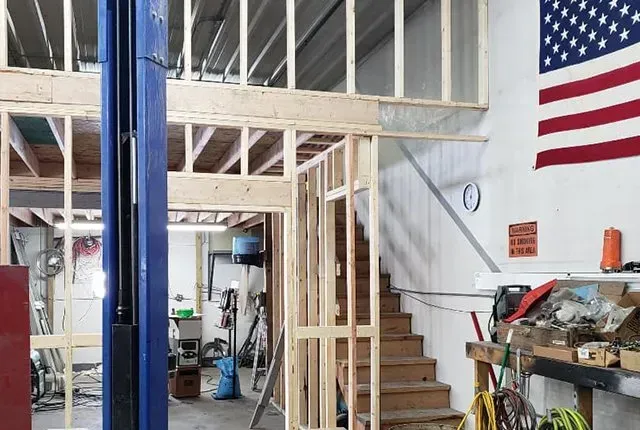 A building under construction with an american flag on the wall.