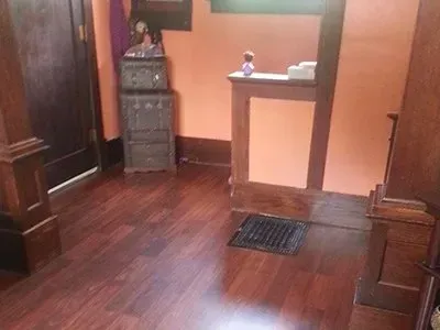 A room with hardwood floors and orange walls.