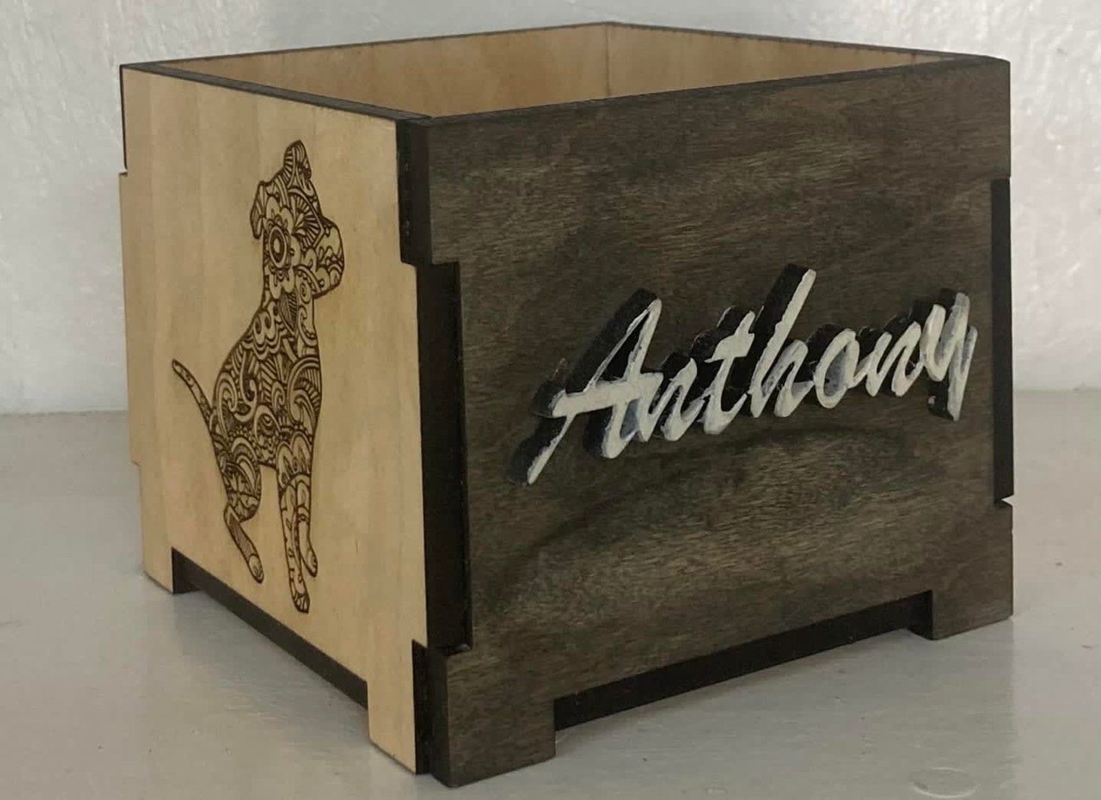 Wooden box with a dog silhouette and the name 
