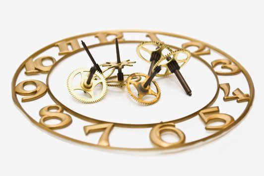A clock with a bicycle and gears on it.