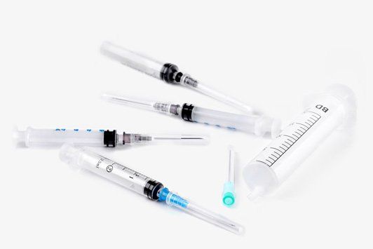 Syringes, needles and syringes on a white background.