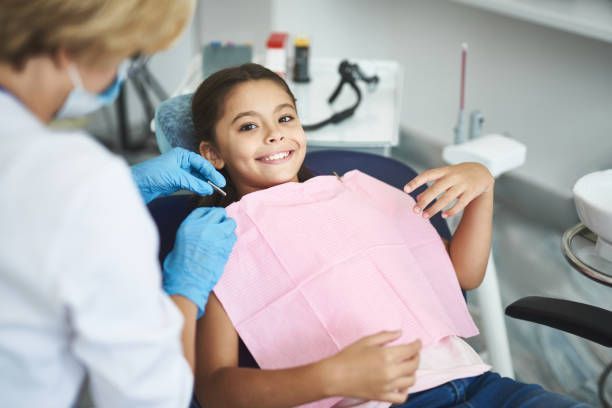 Dental professional examining patient’s teeth during routine checkup in modern dental clinic.