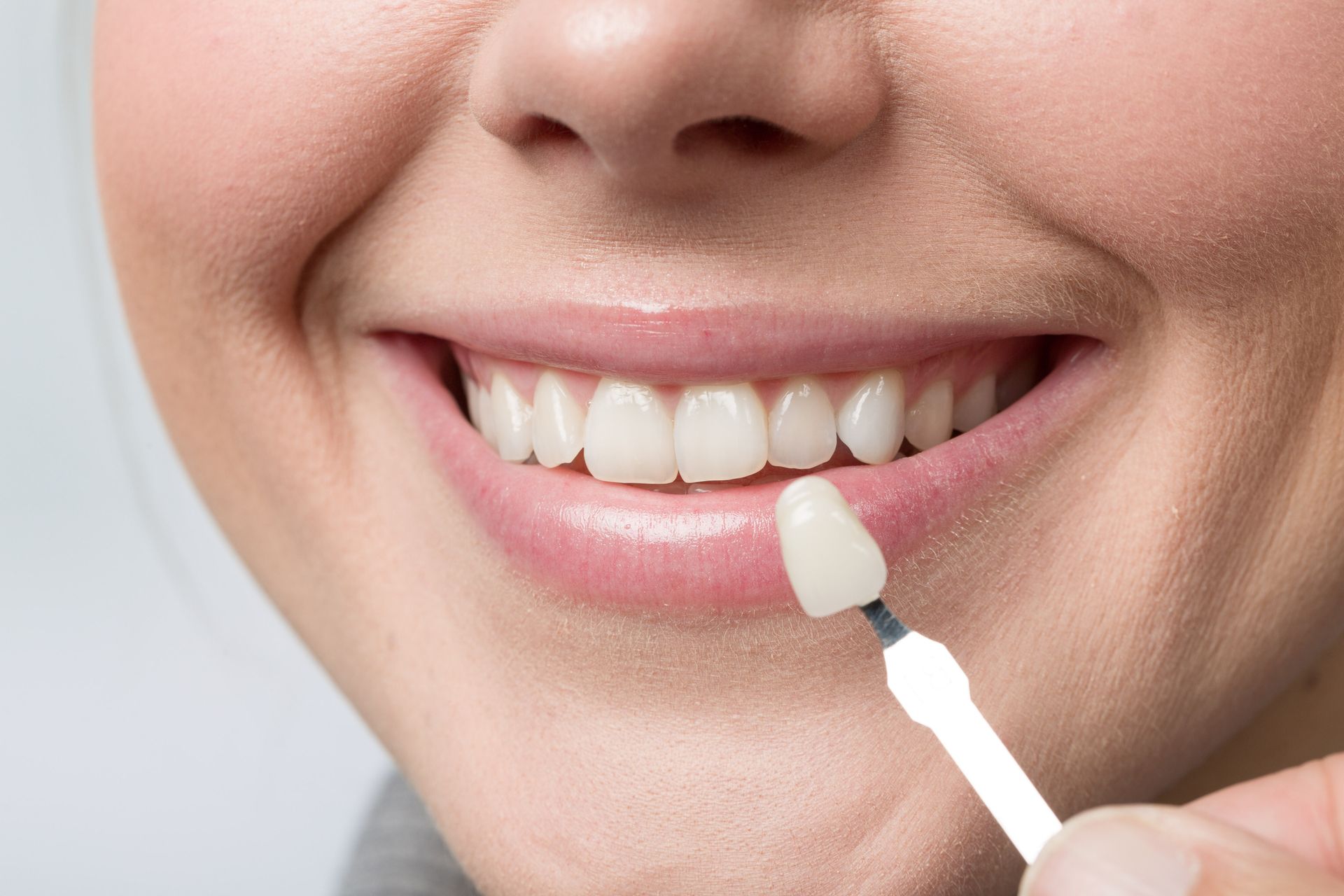 Close-up of a person smiling and cleaning her teeth. Close-up of a person smiling and cleaning her teeth.
