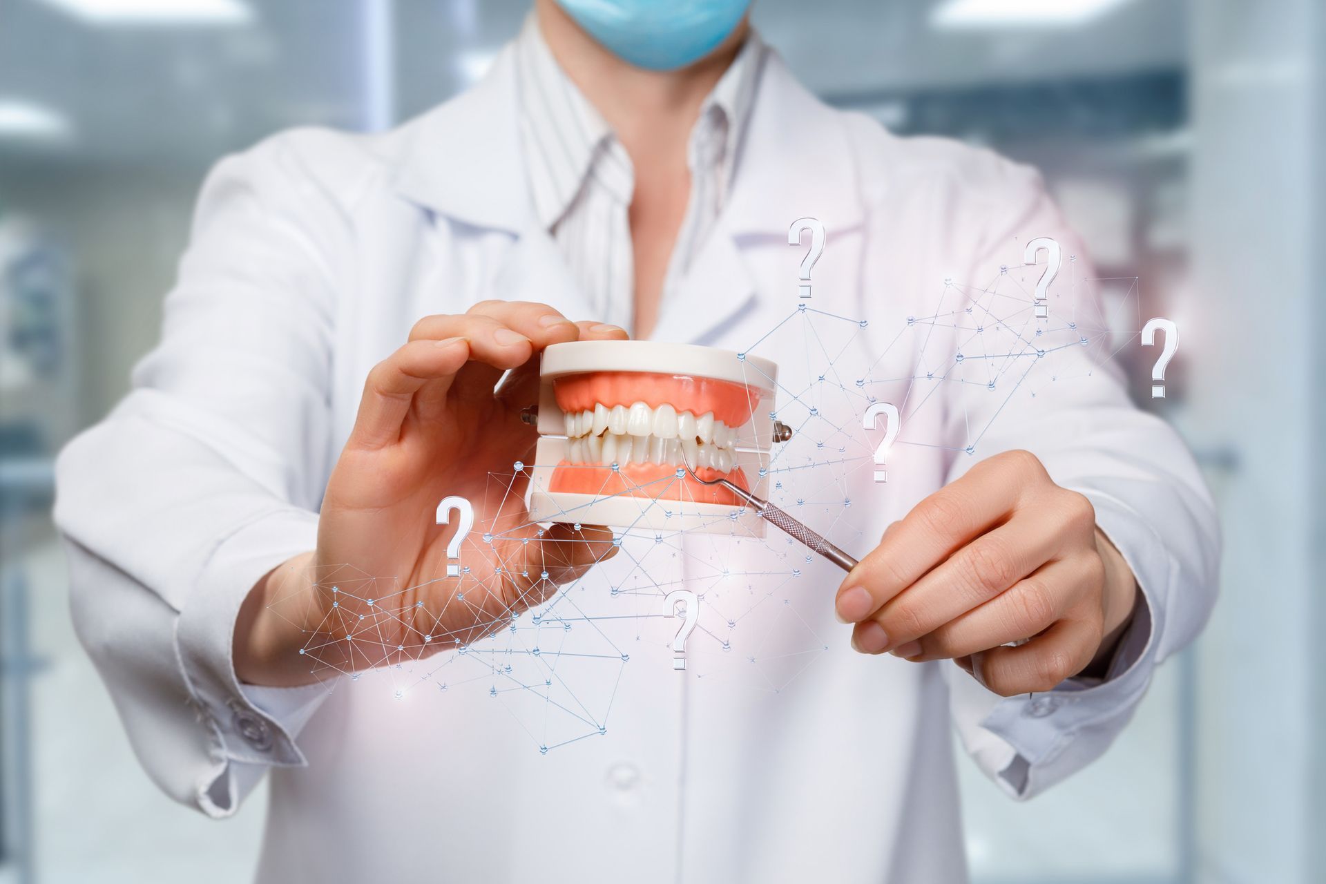Dentist showcasing proper jaw alignment while pointing to an artificial jaw model. Dentist showcasing proper jaw alignment while pointing to an artificial jaw model.