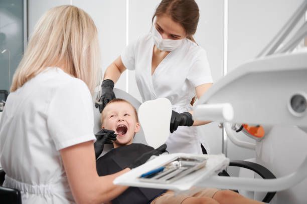 At Rabel Family Dental in Baton Rouge, LA, two female dentists perform a pediatric dentistry 