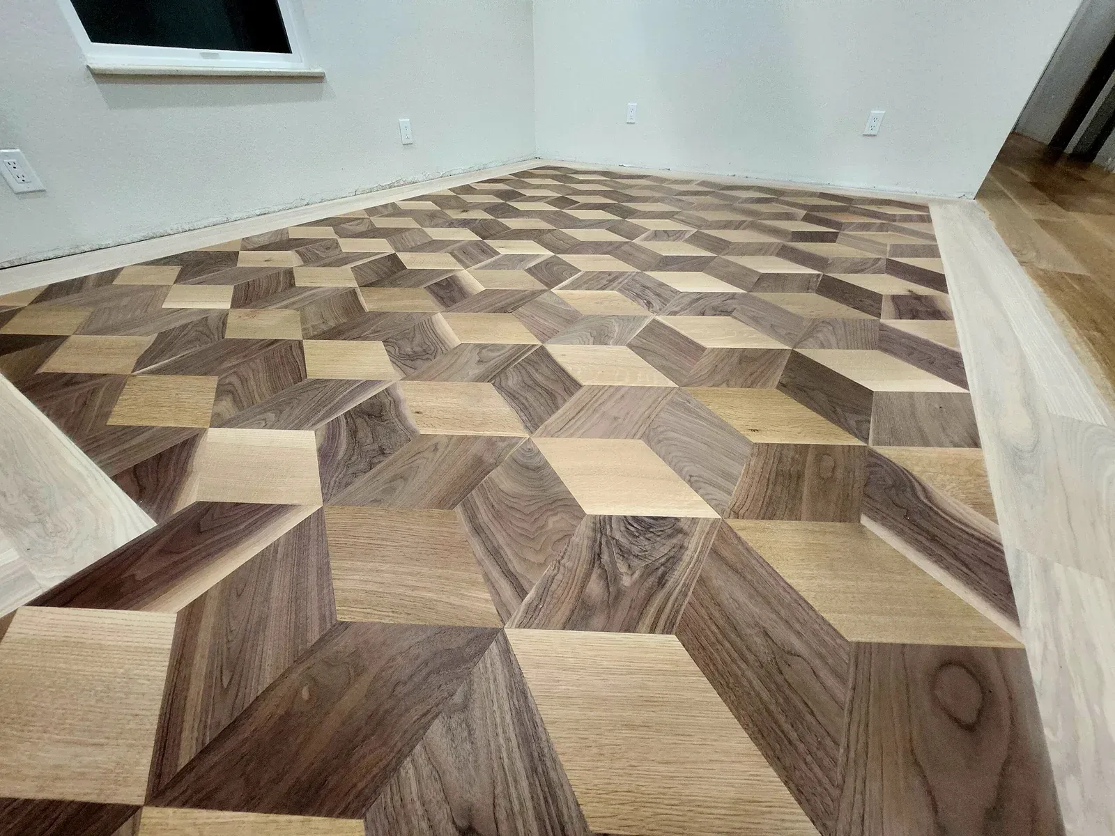 Geometric wood floor pattern creates a 3D optical illusion, with light and dark brown tones.