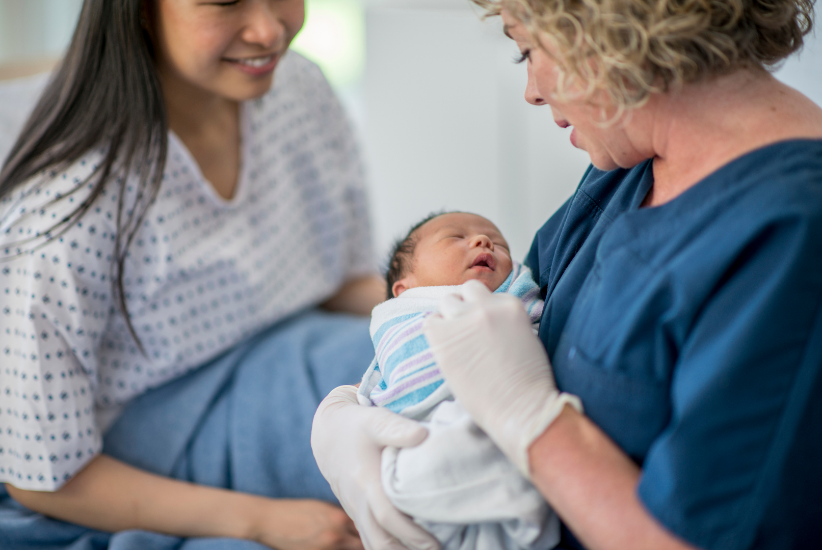 Mother with Newborn Baby and Nurse
