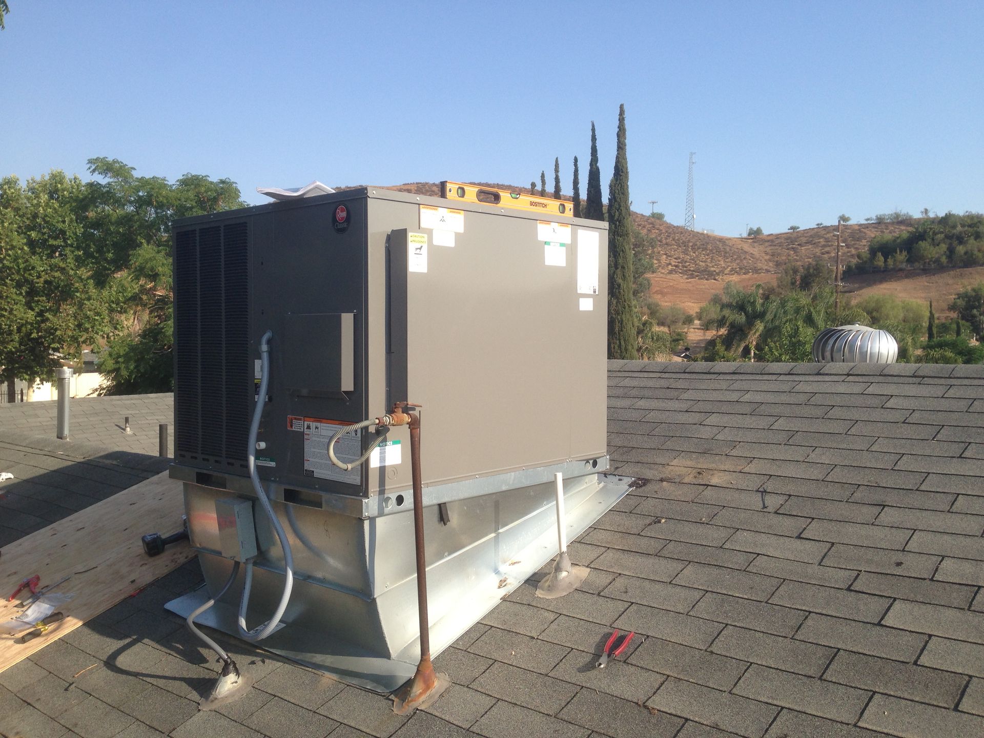 A large box is sitting on top of a roof.