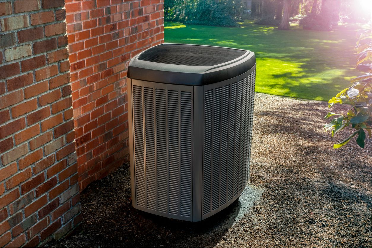 HVAC technician inspecting an older air conditioner unit in a residential backyard.