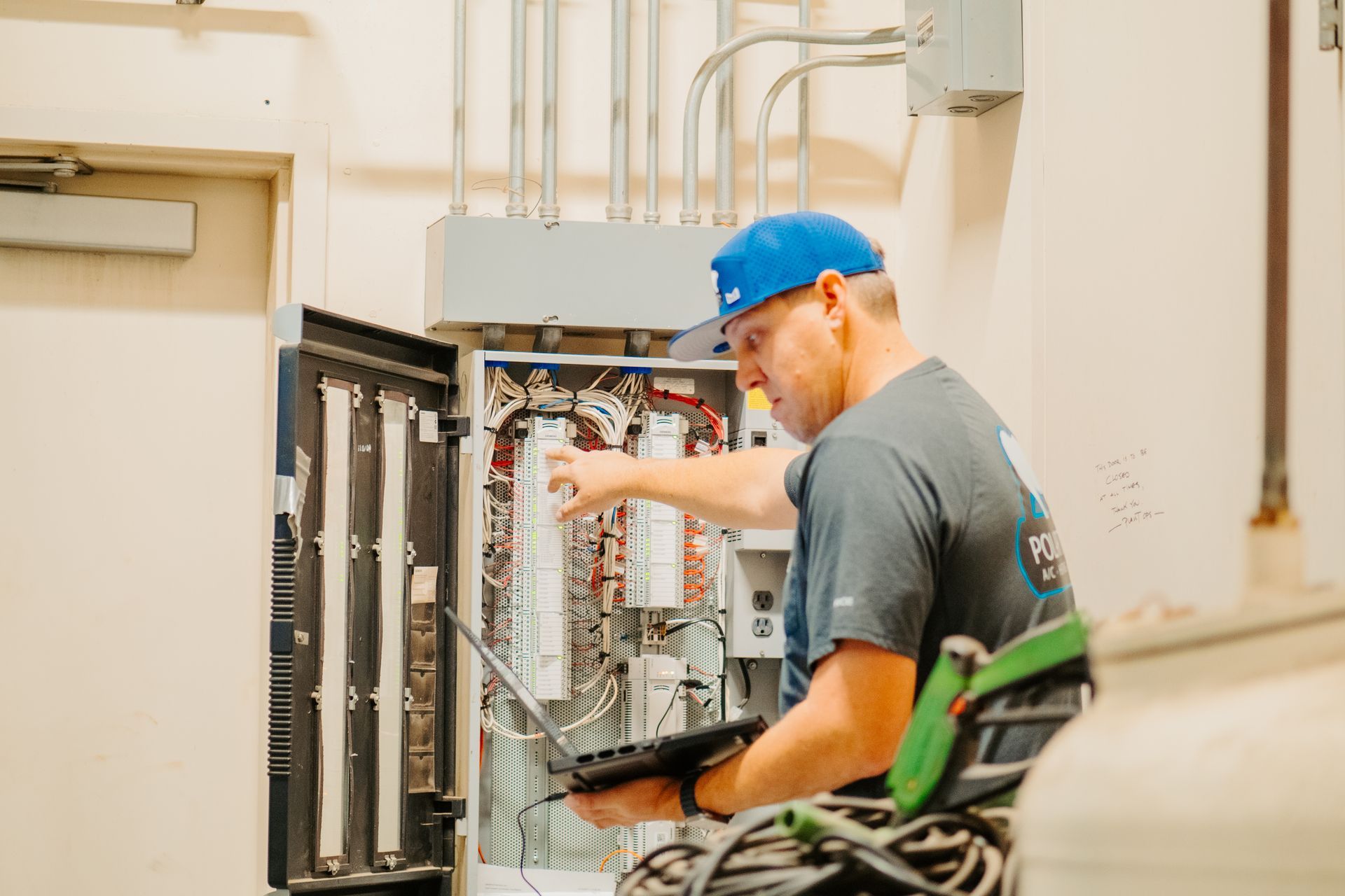 A family is sitting on a couch with a laptop.