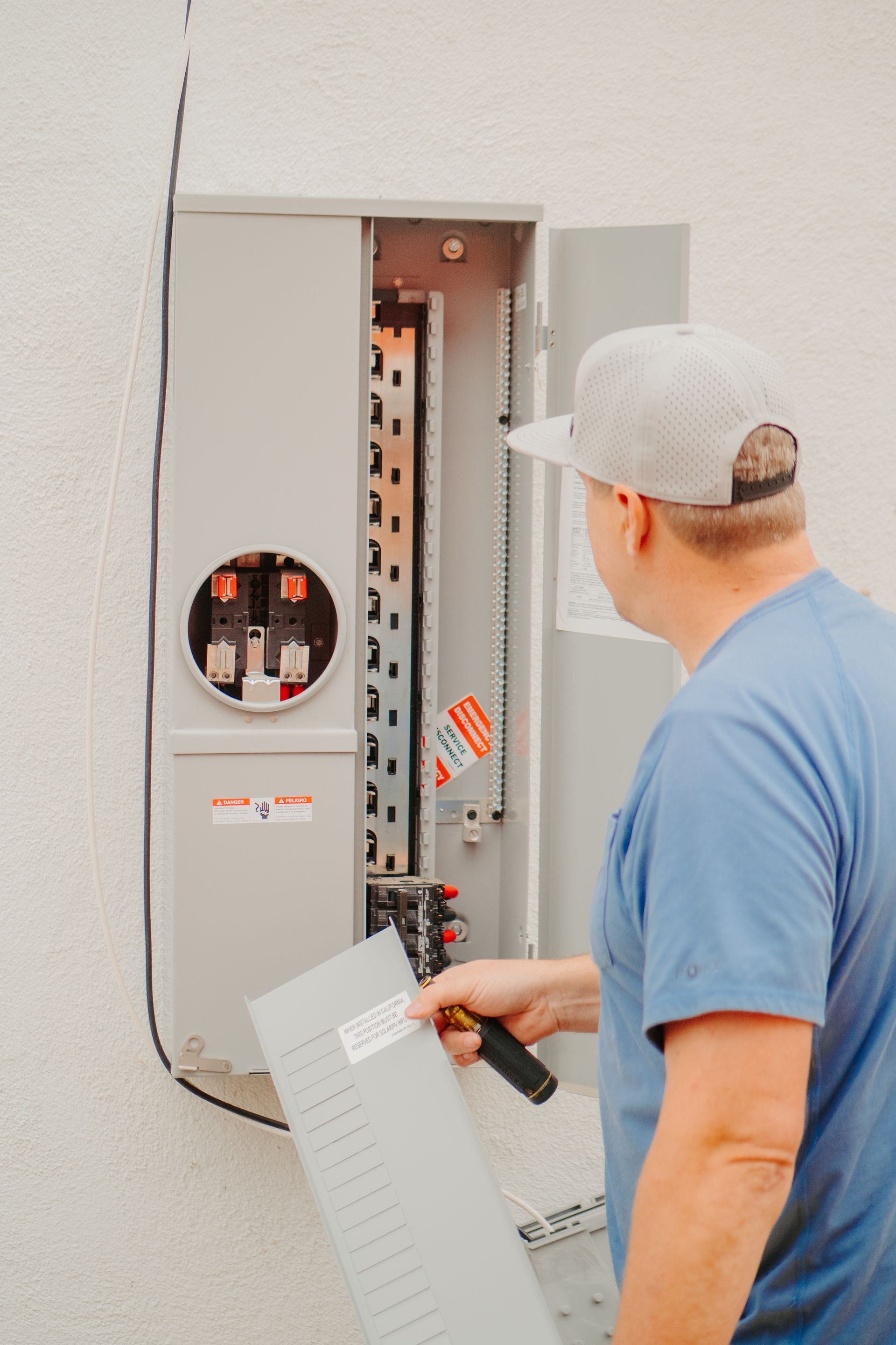 A man is standing next to an air conditioner holding a clipboard.