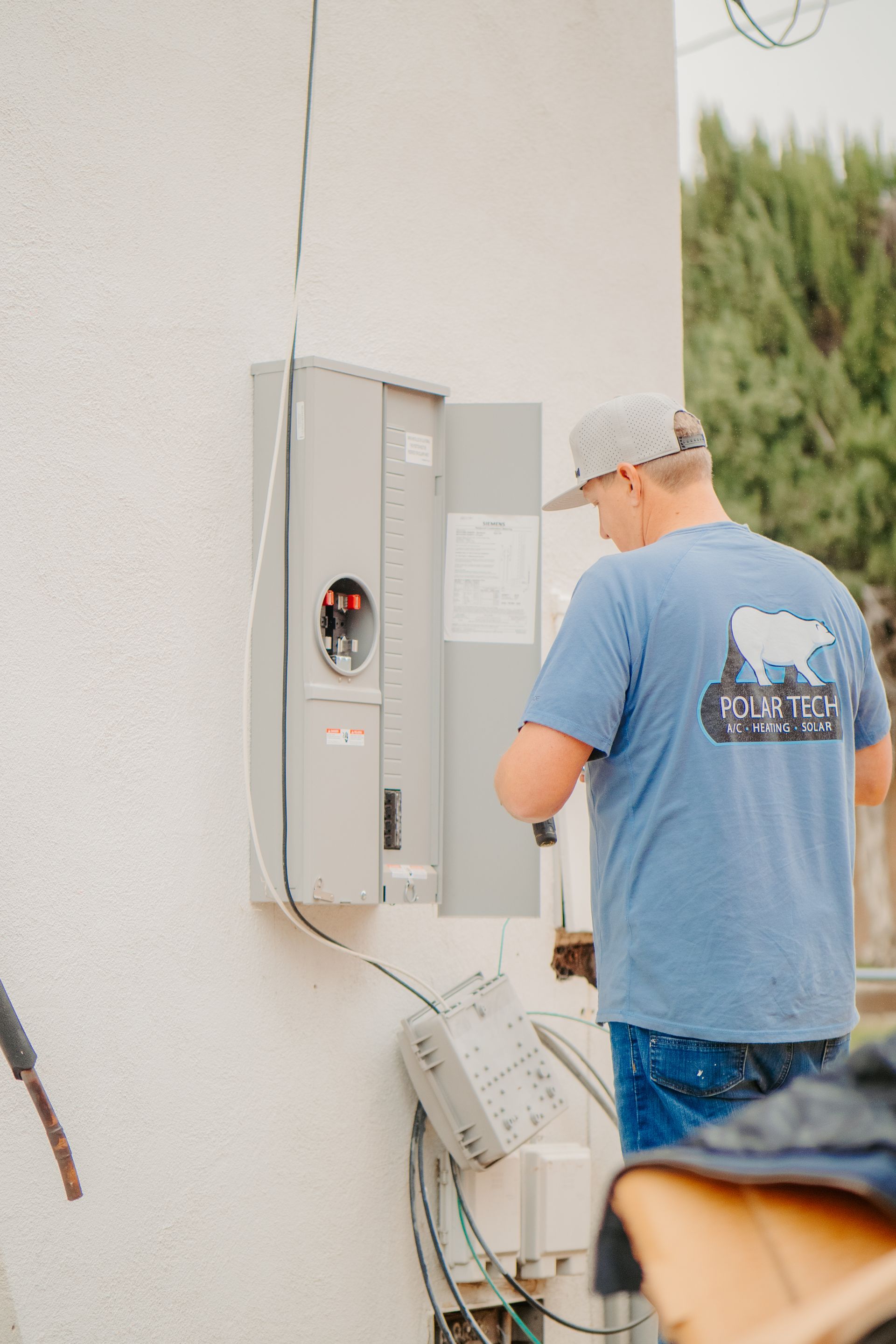 A furnace is sitting in a corner of a room.