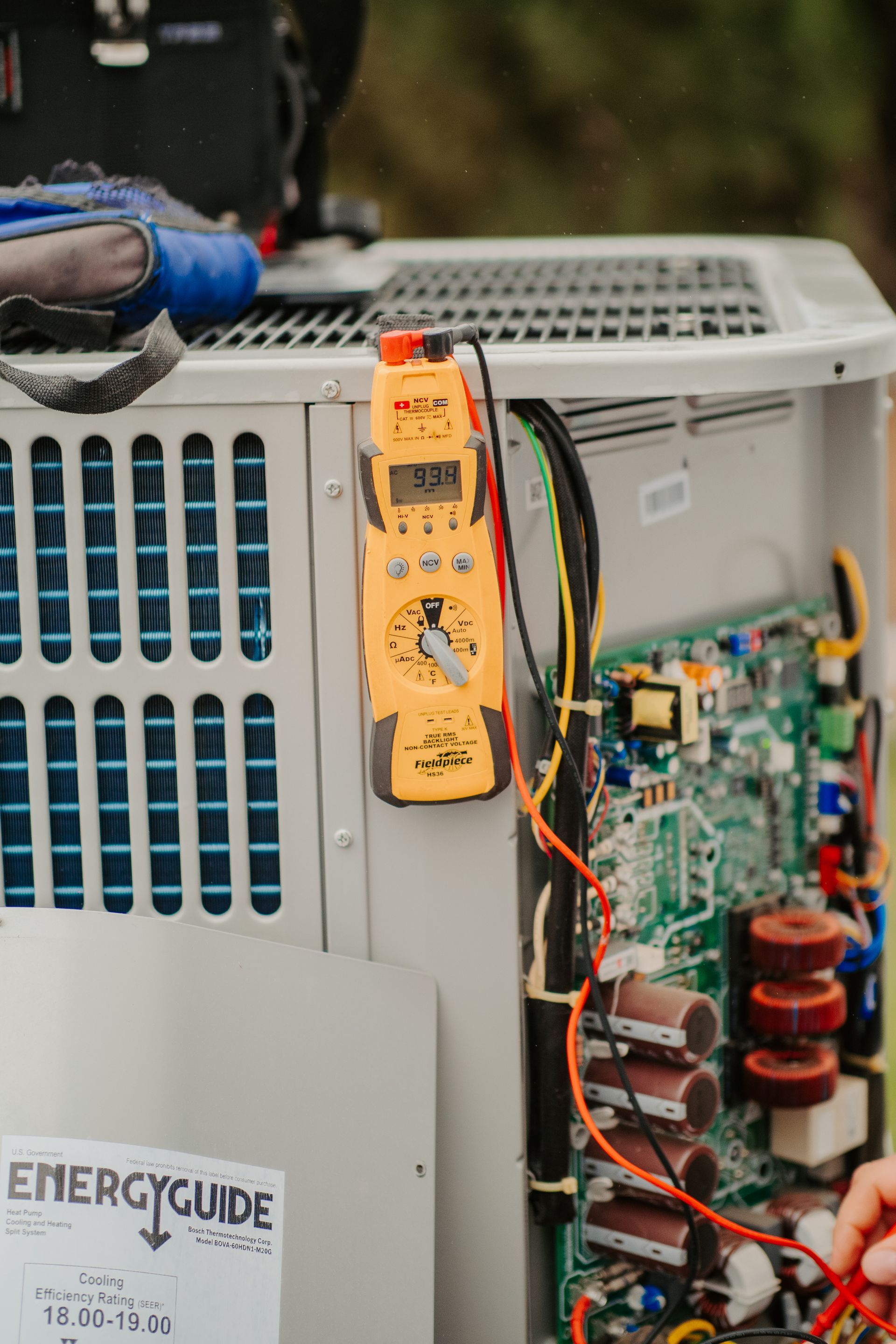 A midea air conditioner is attached to the side of a building.