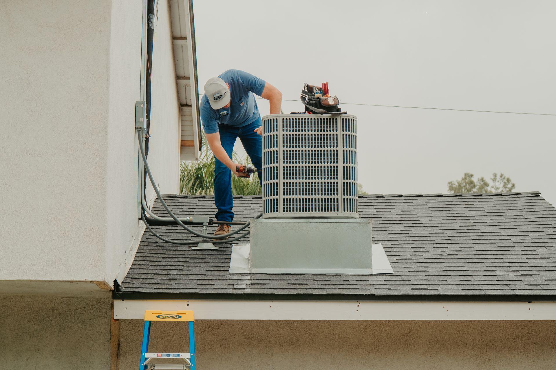 An air conditioner is sitting inside of a metal box in a room.