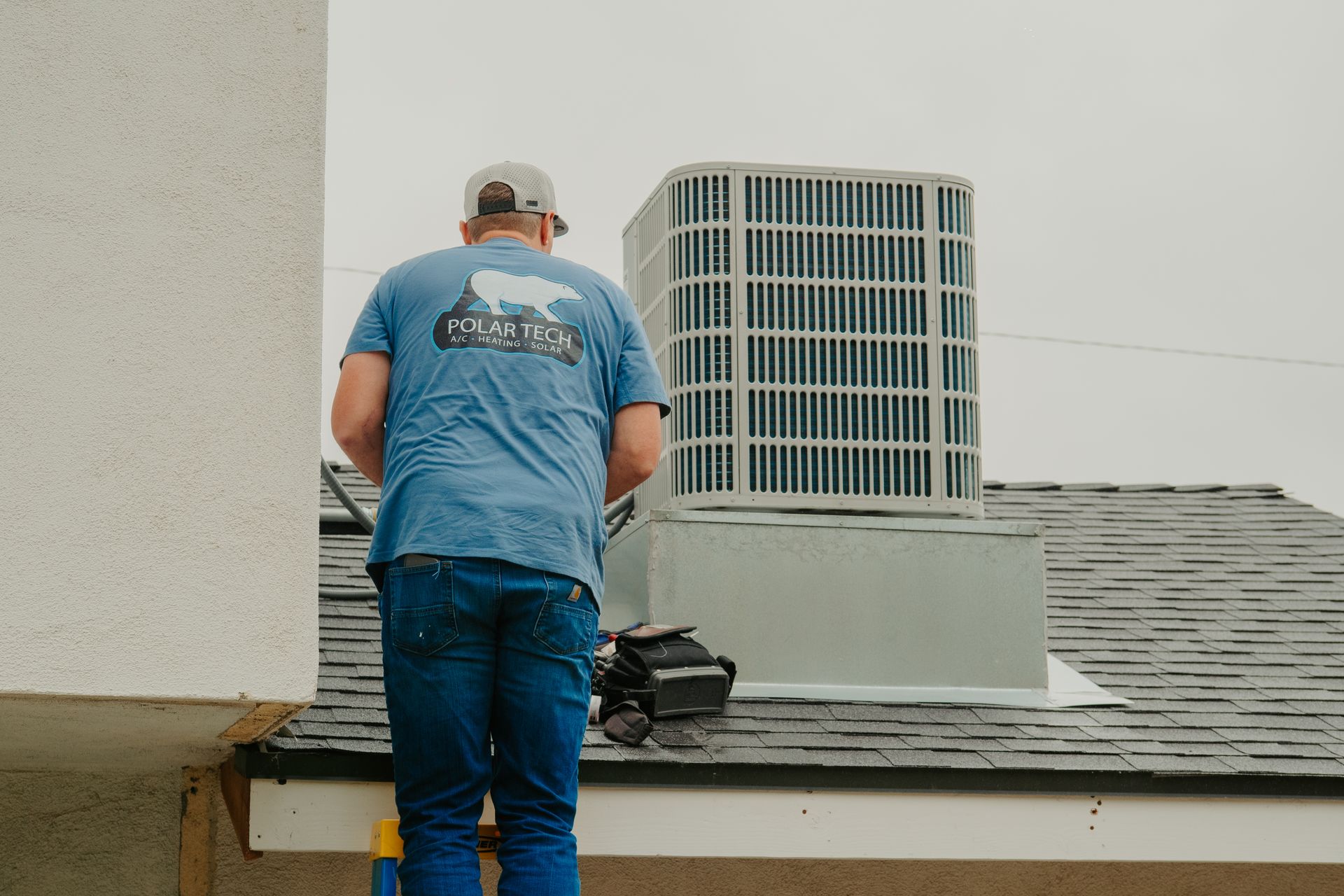 A man and a woman are sitting on a couch looking at a tablet.