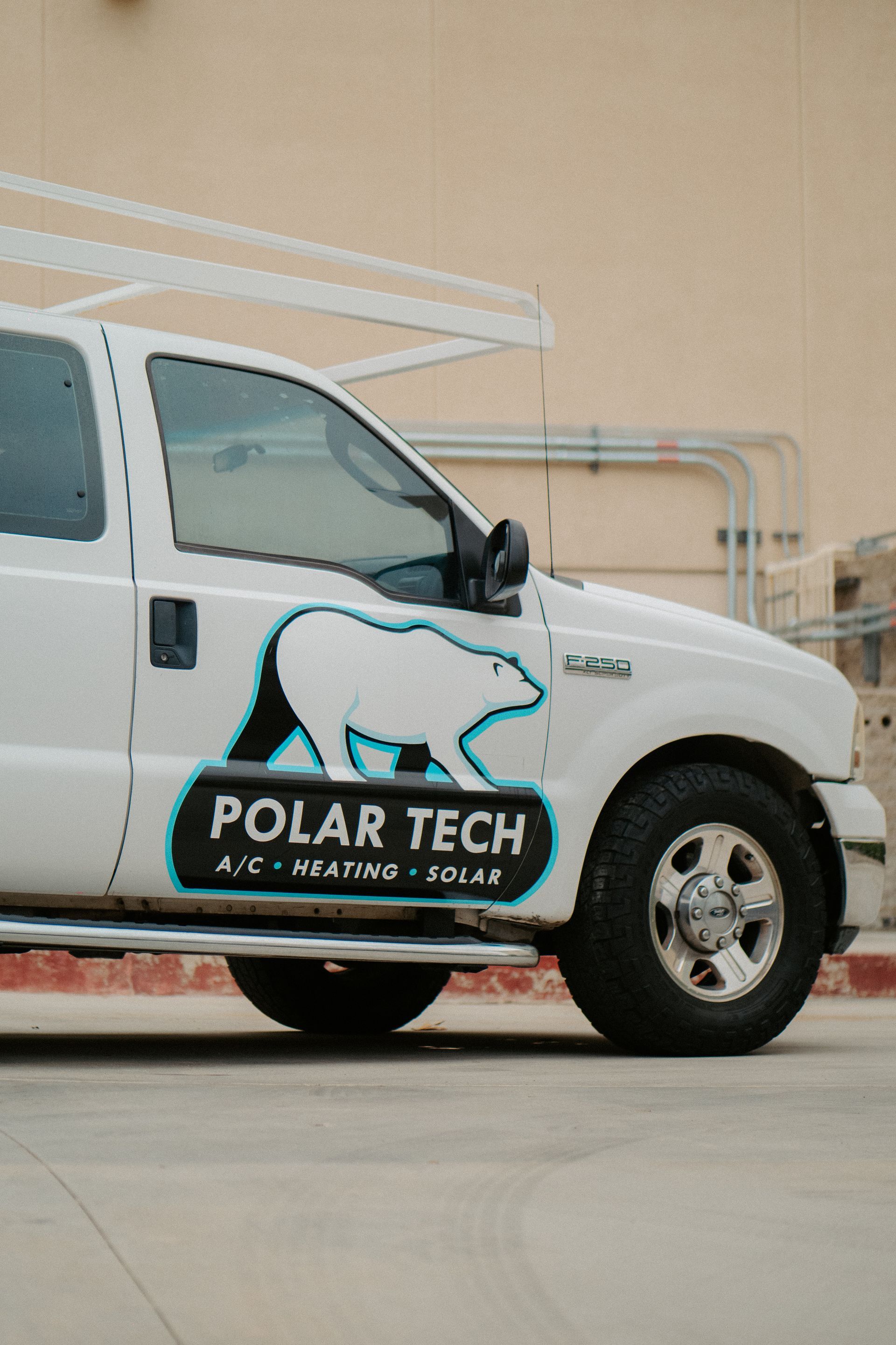 An air conditioner is sitting on top of a concrete block.