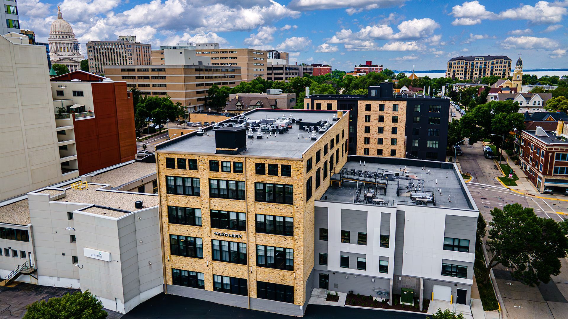Photo of outside of The Saddlery Madison with Downtown Madision WI in background