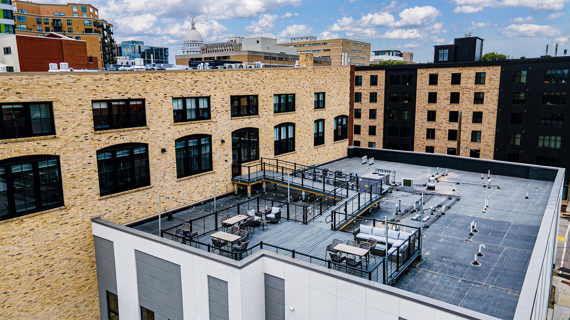 Photo of outside of The Saddlery Madison with Downtown Madision WI in background