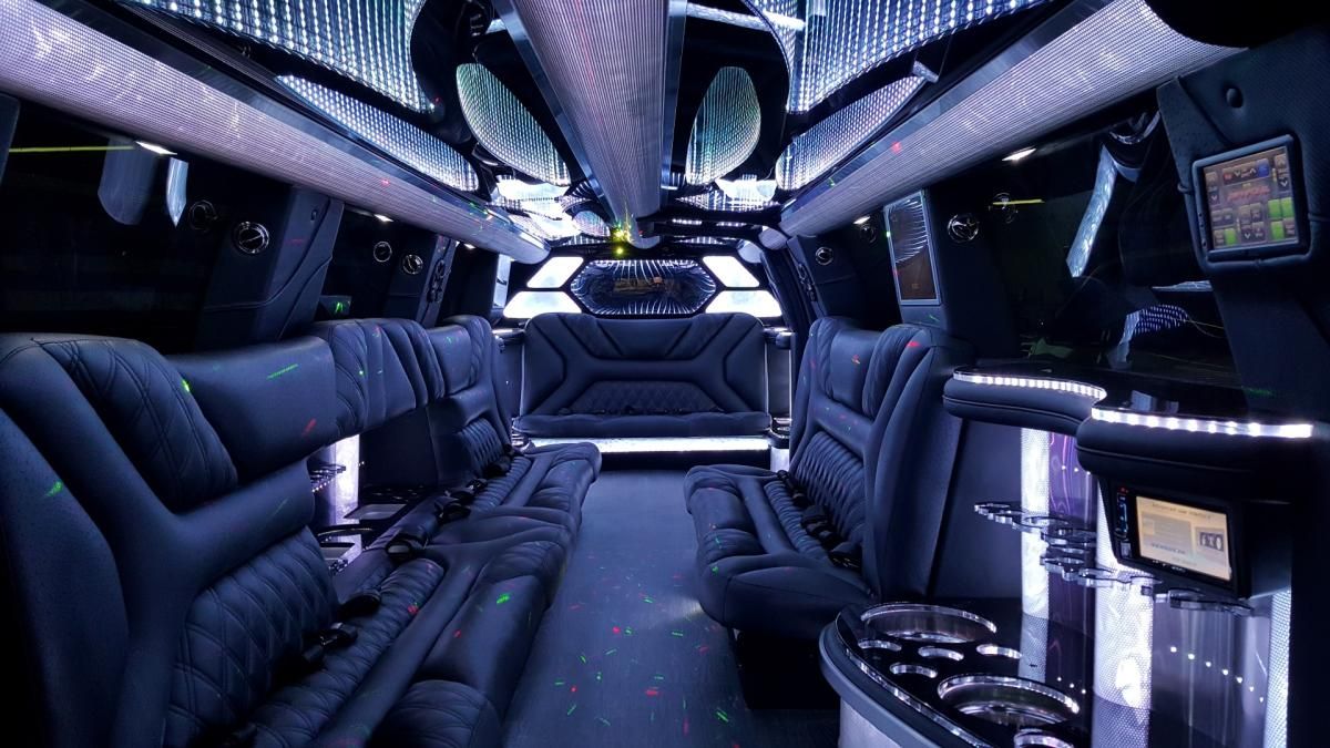 The inside of a limousine with lots of seats and lights.