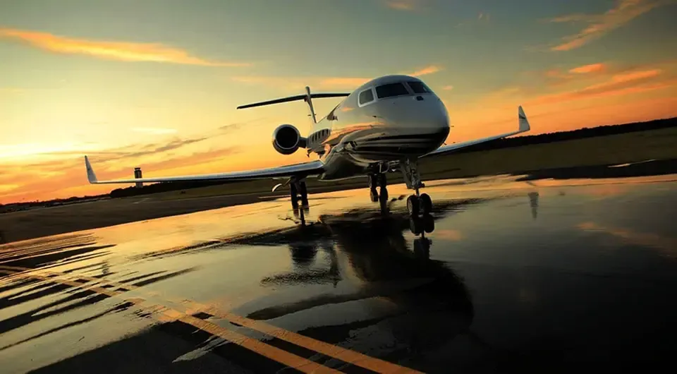 A plane is parked on the runway at an airport
