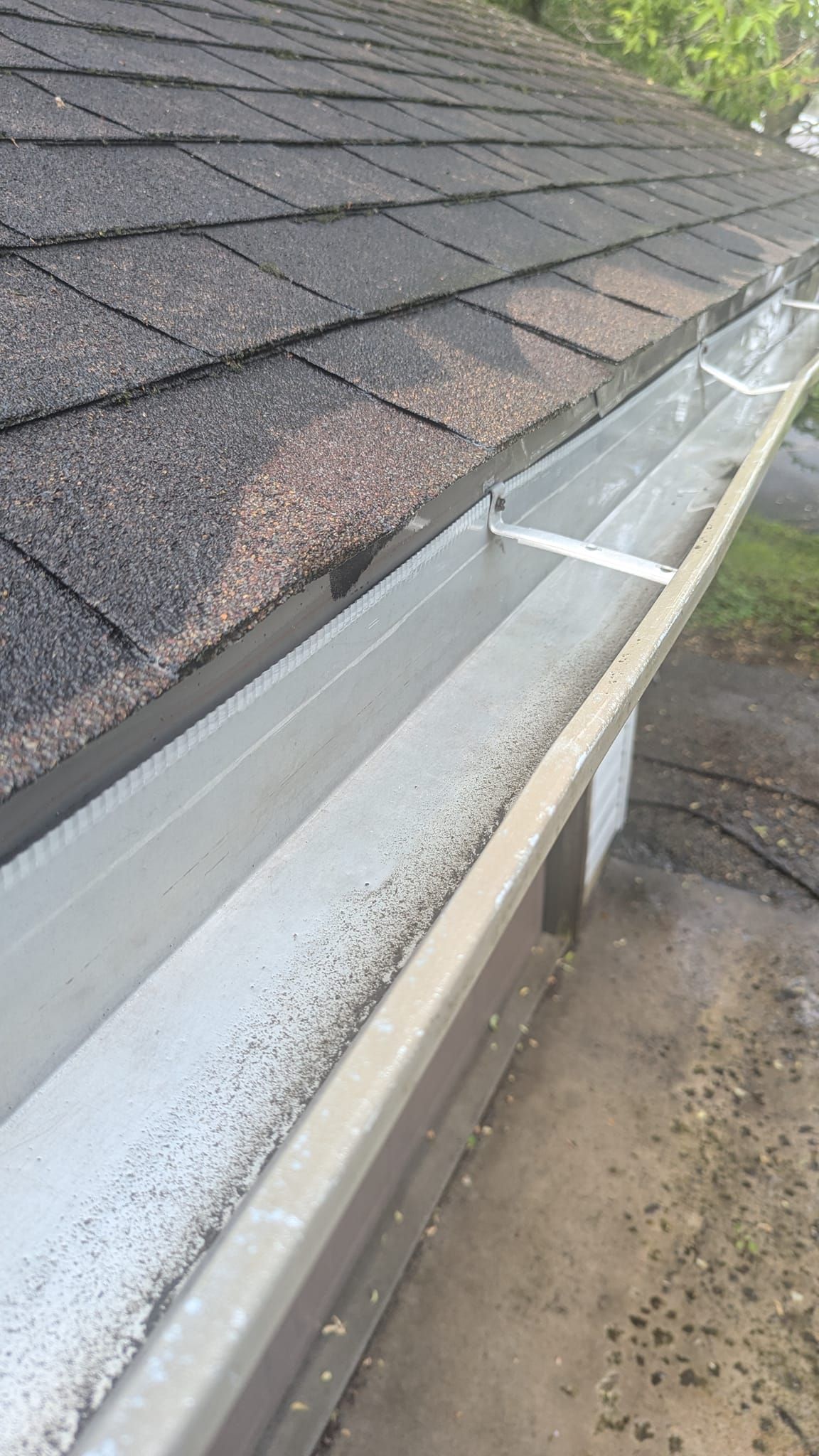 A close up of a gutter on a roof of a house.