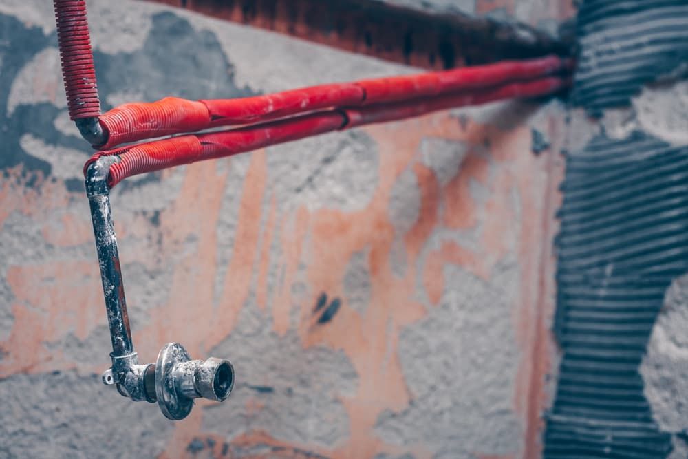 A Red Pipe and a Hose Attached to a Wall