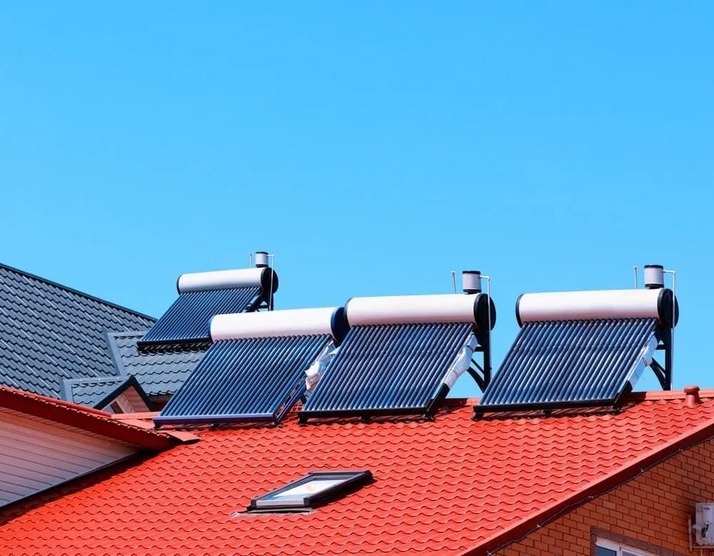There Are Three Solar Panels On The Roof Of A House — Malouf Plumbing In Pie Creek, QLD