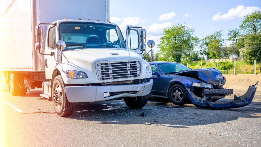 a white truck and a blue car are involved in an accident