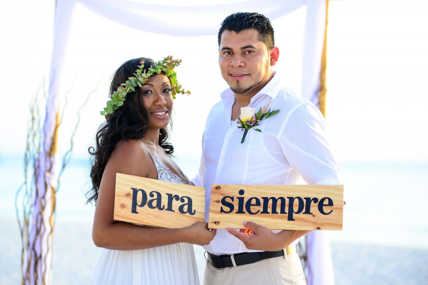 Couple holding wooden signs that read