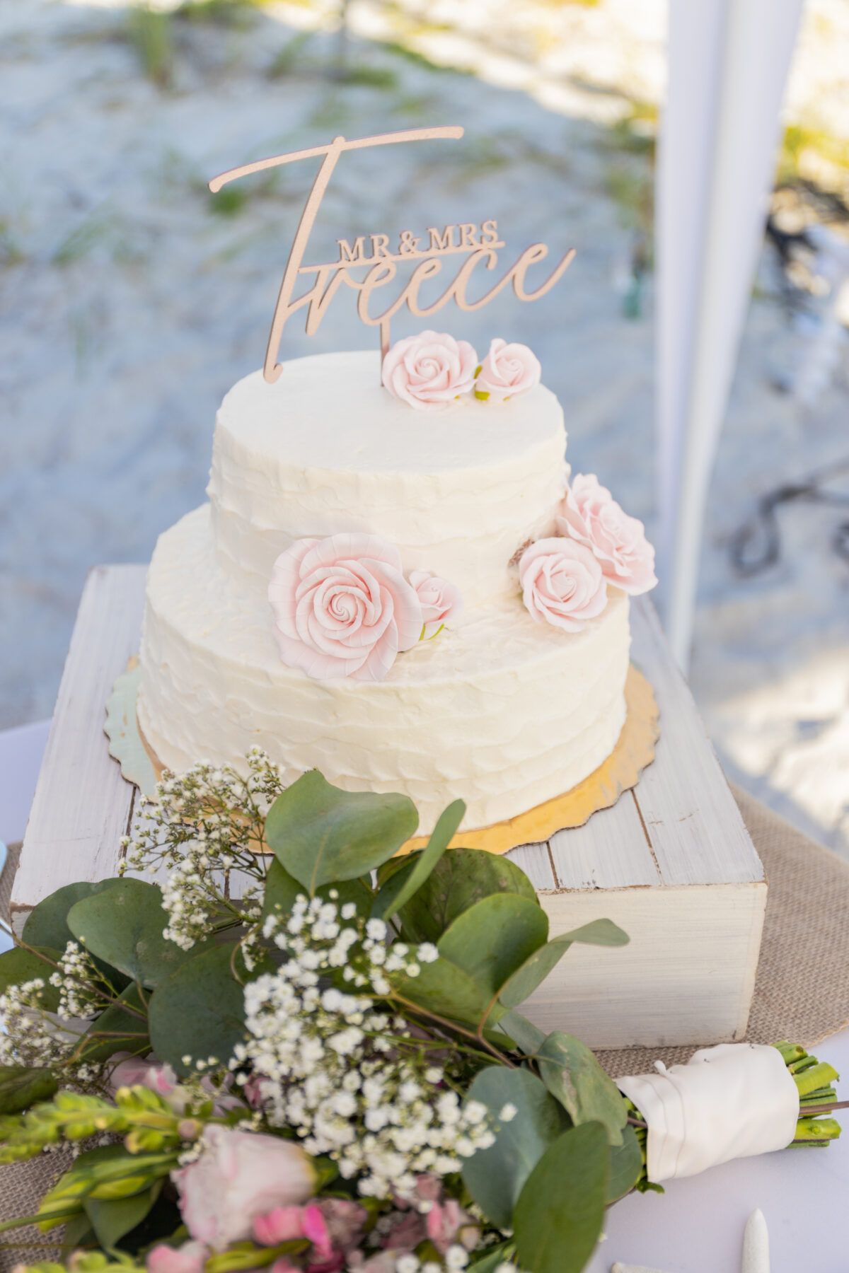 Two-tiered wedding cake with pink roses and 