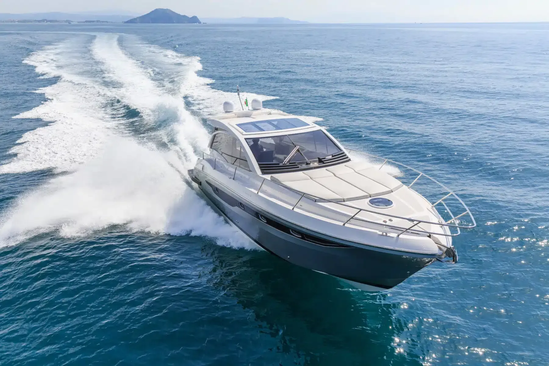 A boat is floating on top of a body of water.