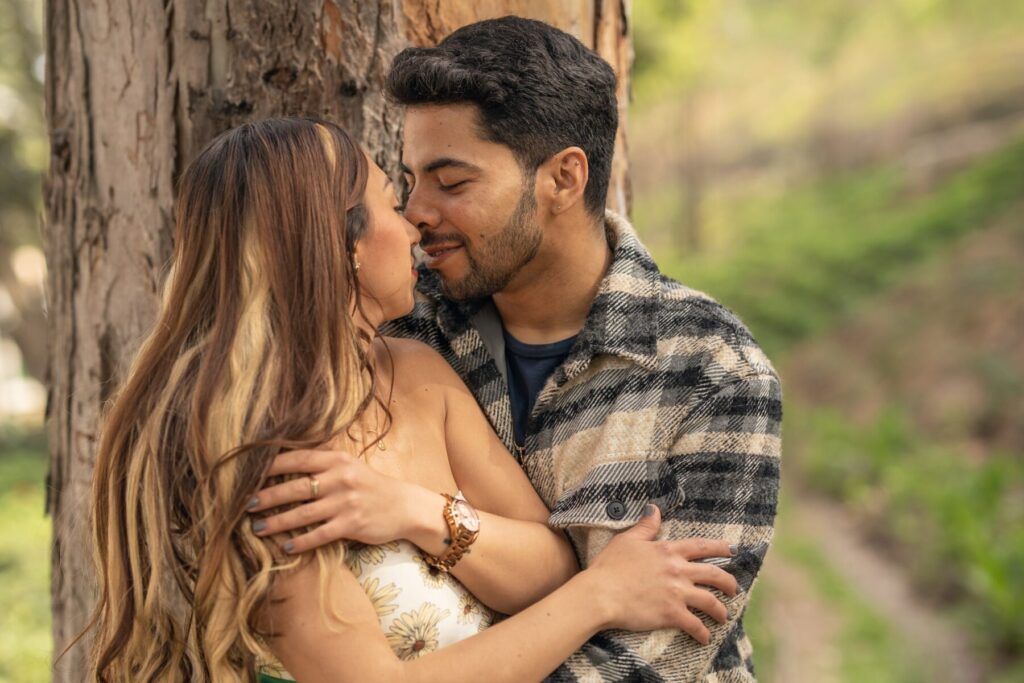 Lovers about to kiss in a park