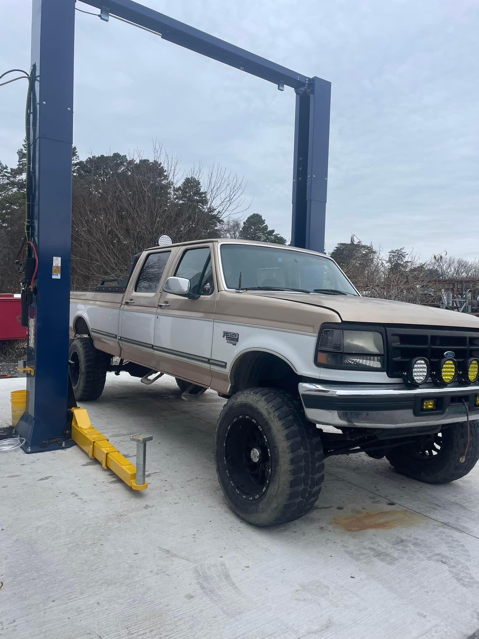A truck is parked on a lift in the snow.