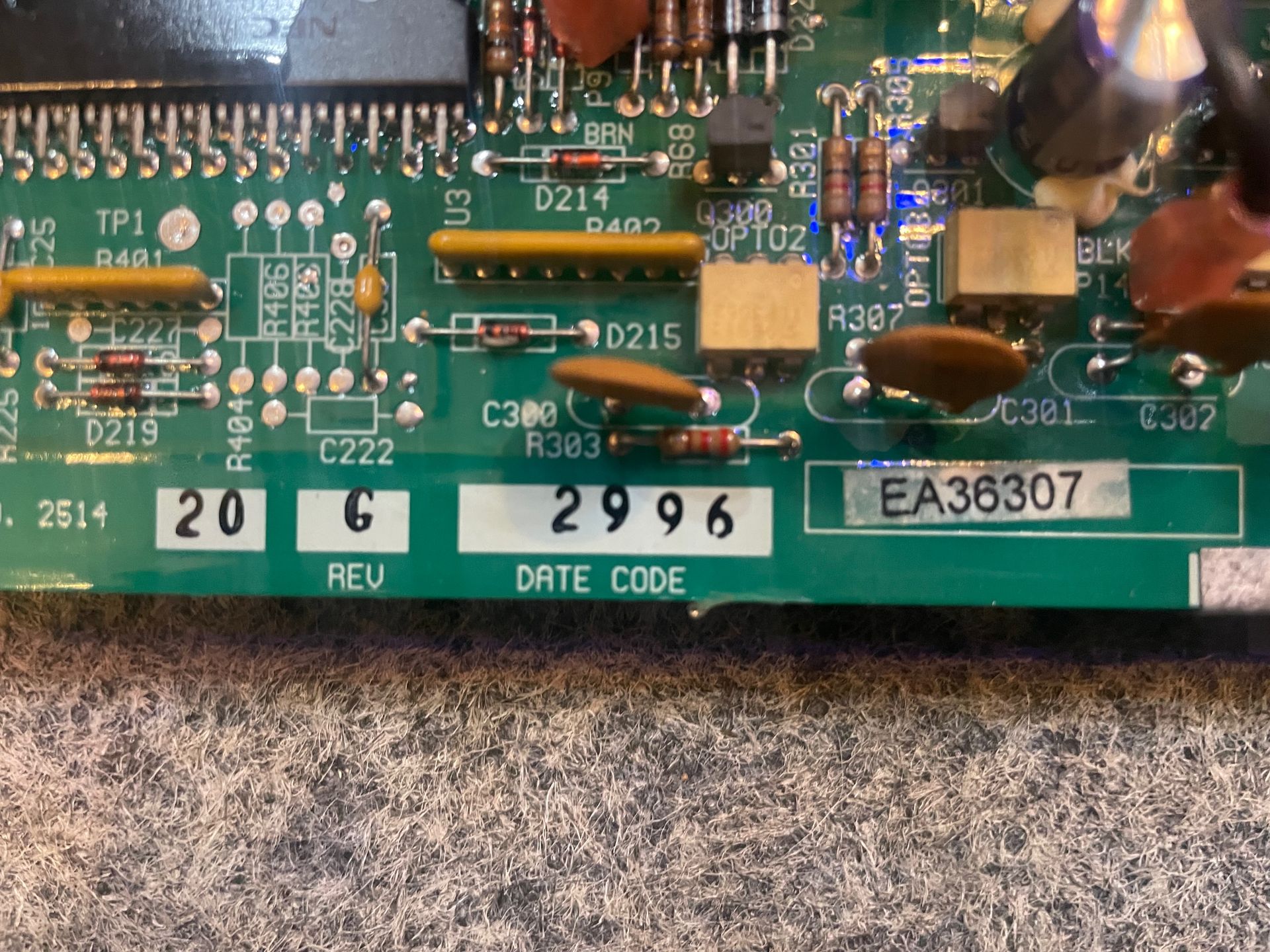 Green circuit board with electronic components, date code 