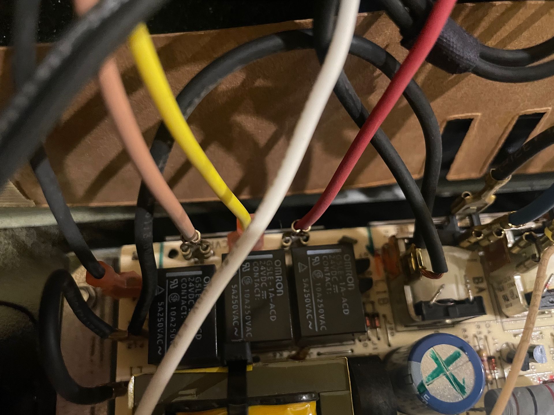 Wiring of electronic components; several colored wires connect to relays on a circuit board.